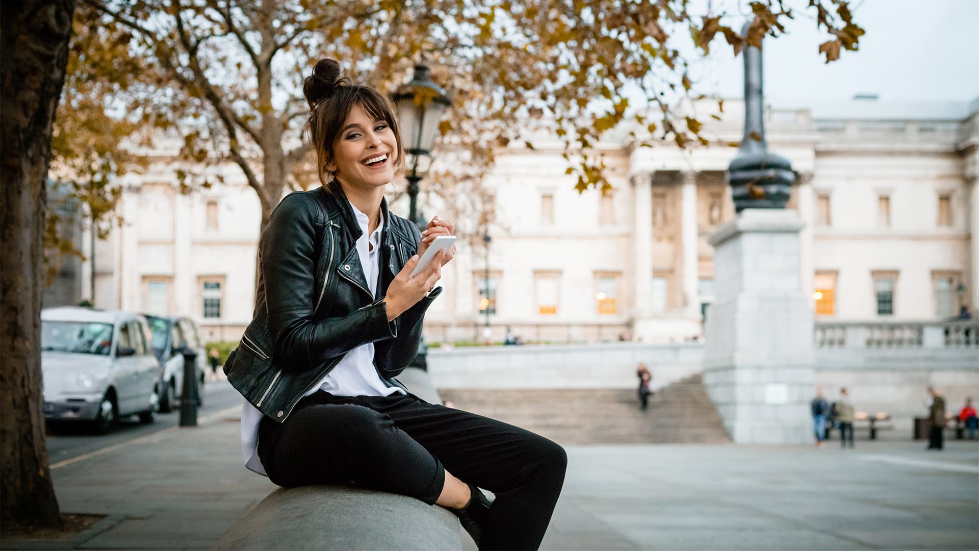 woman smiling trafalgar square london phone