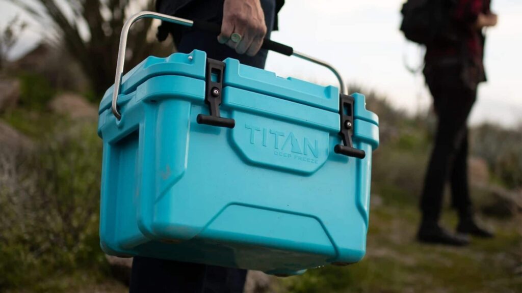 person holding a blue titan cooler