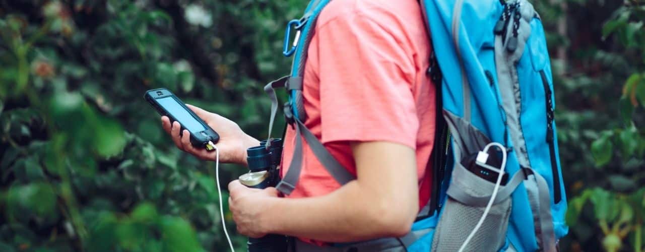 hiker holding charging phone