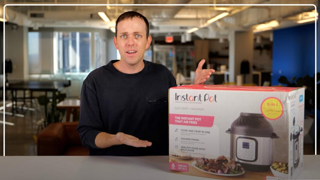 Pete standing next to instant pot duo crisp box in kitchen presenting ready to unbox