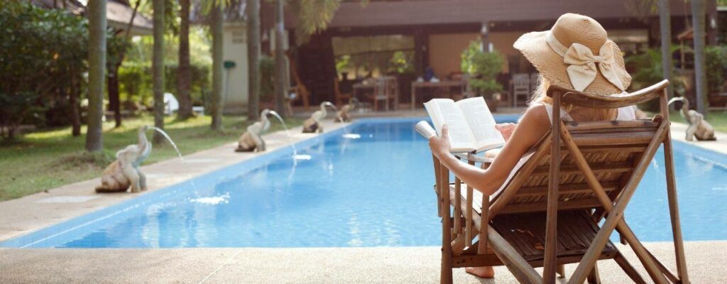 woman reading by the pool