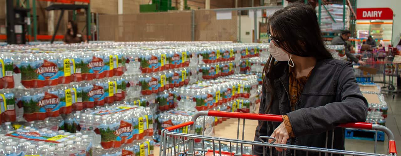 albuquerque-new-mexico-usa-march-12-2020-woman-wearing-face-mask-with-cart-shops-for-water-bottles-in