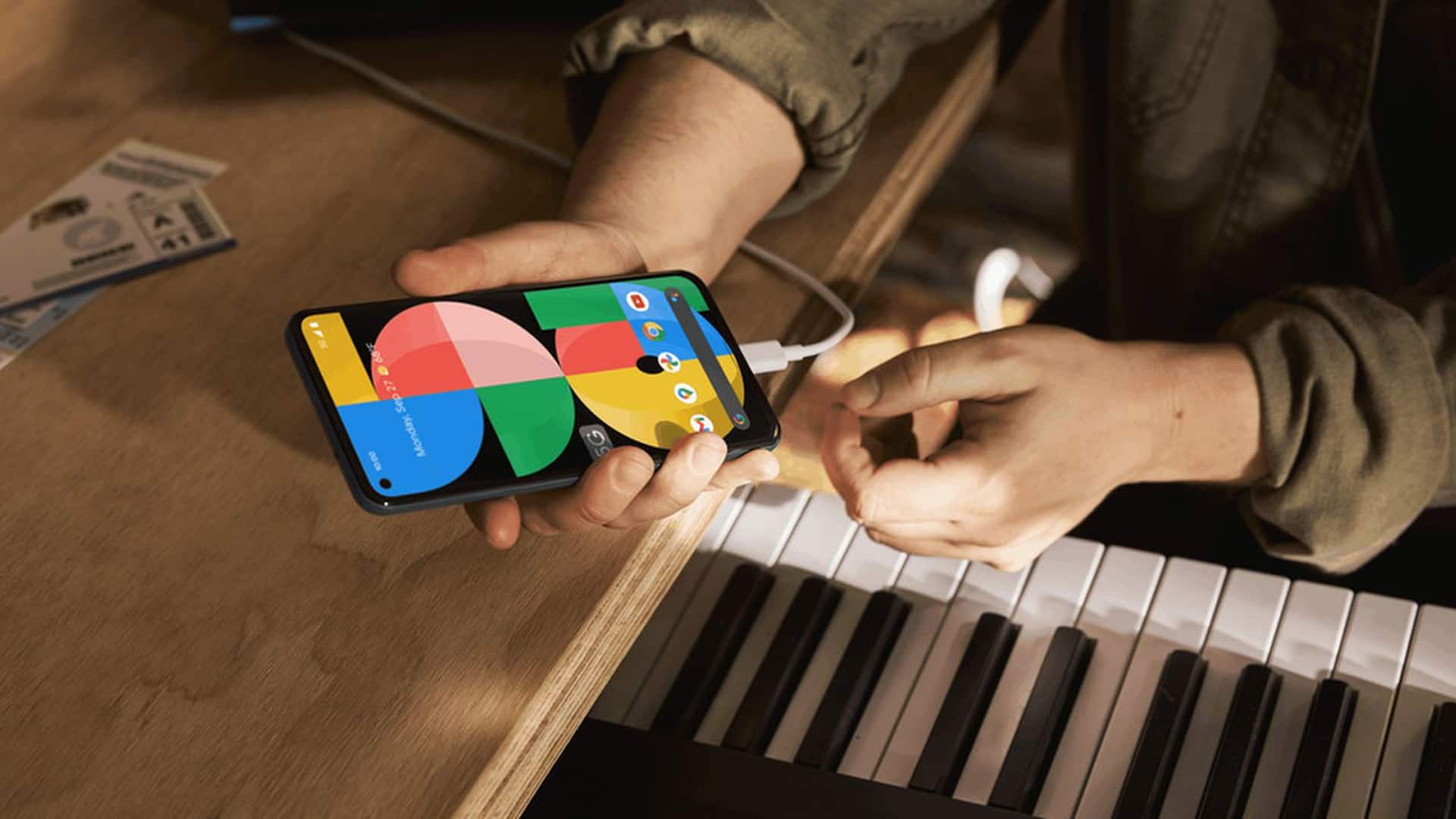 google pixel 5a charging over a piano keyboard