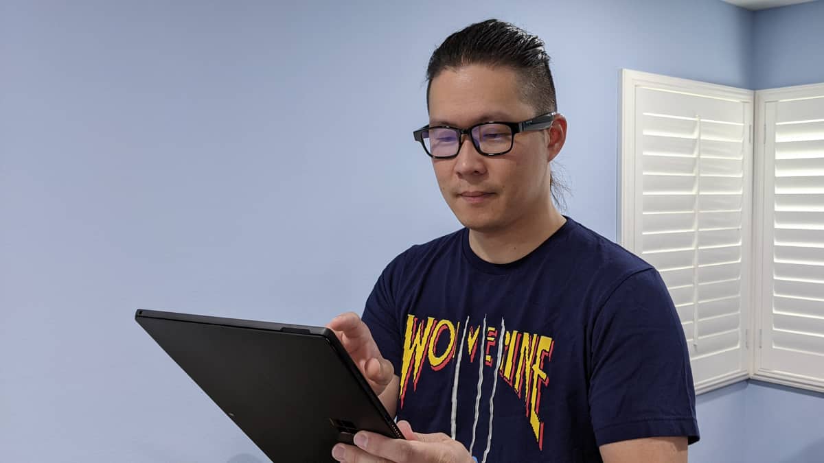 person using tablet wearing razer anzu smart glasses