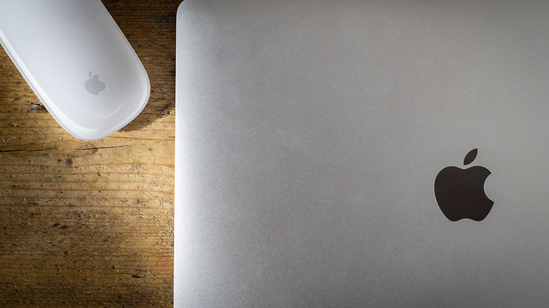 Macbook pro on desk with mouse