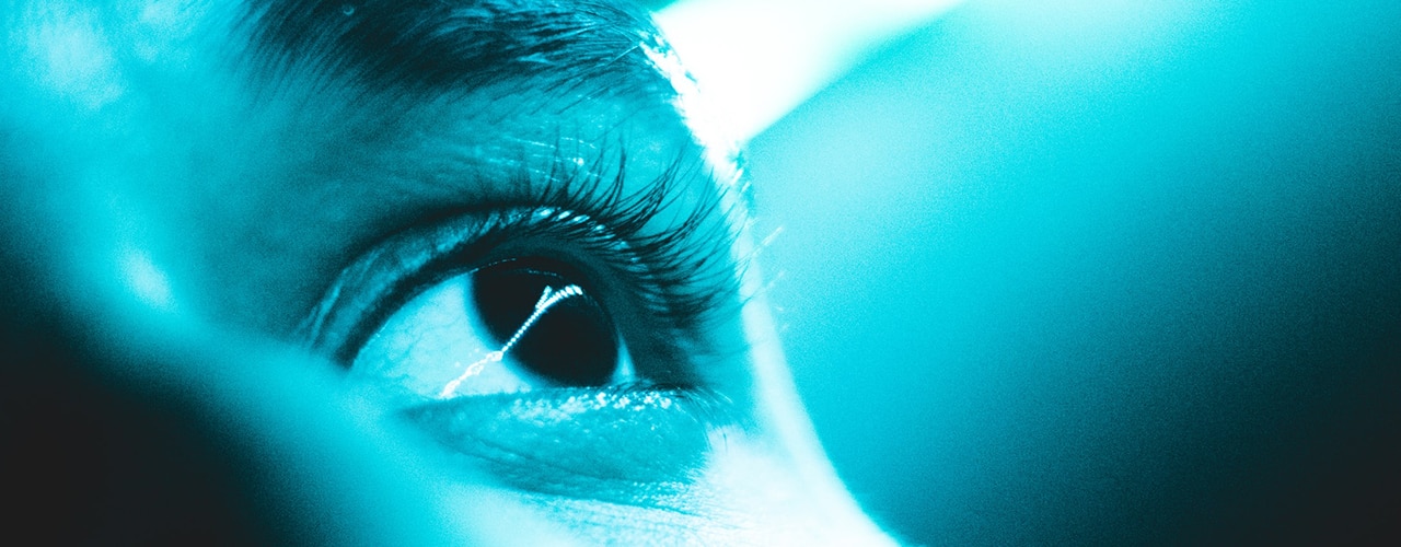 closeup of eye with blue light