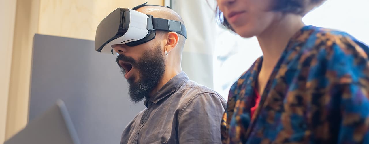 excited man wearing VR headset