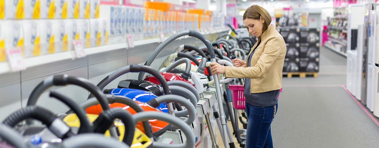 woman shopping for vacuum cleaners