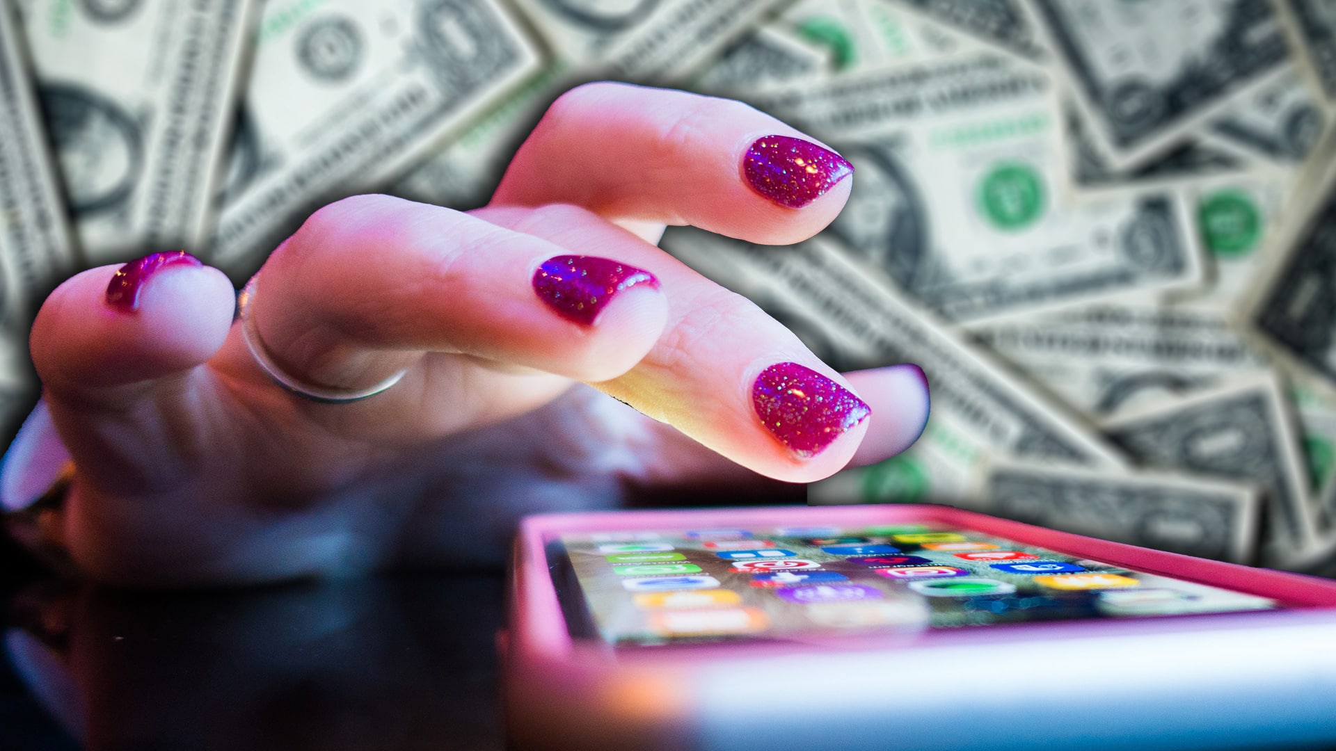 womans hand and smart phone over money backdrop