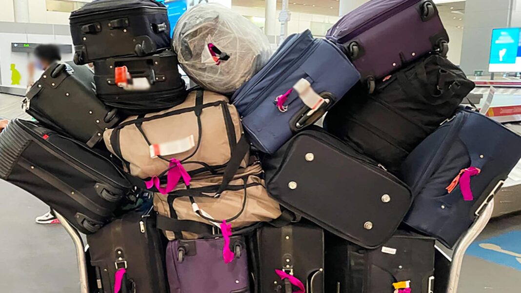 pile of unclaimed luggage at airport