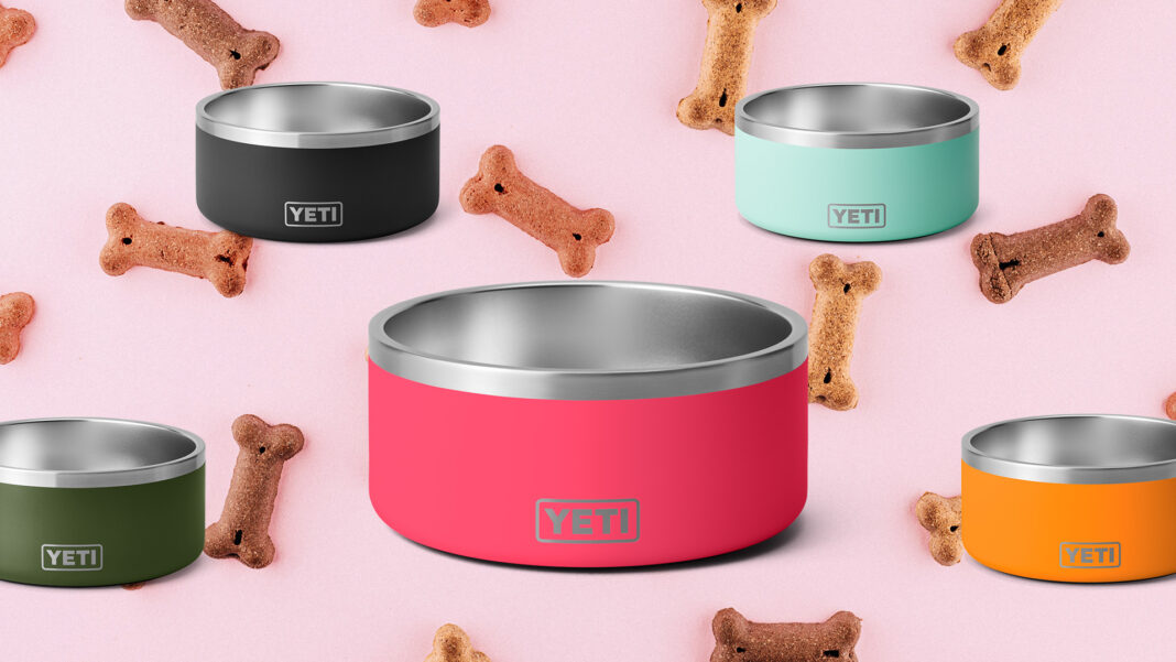 YETI dog bowls on pink background with dog bones