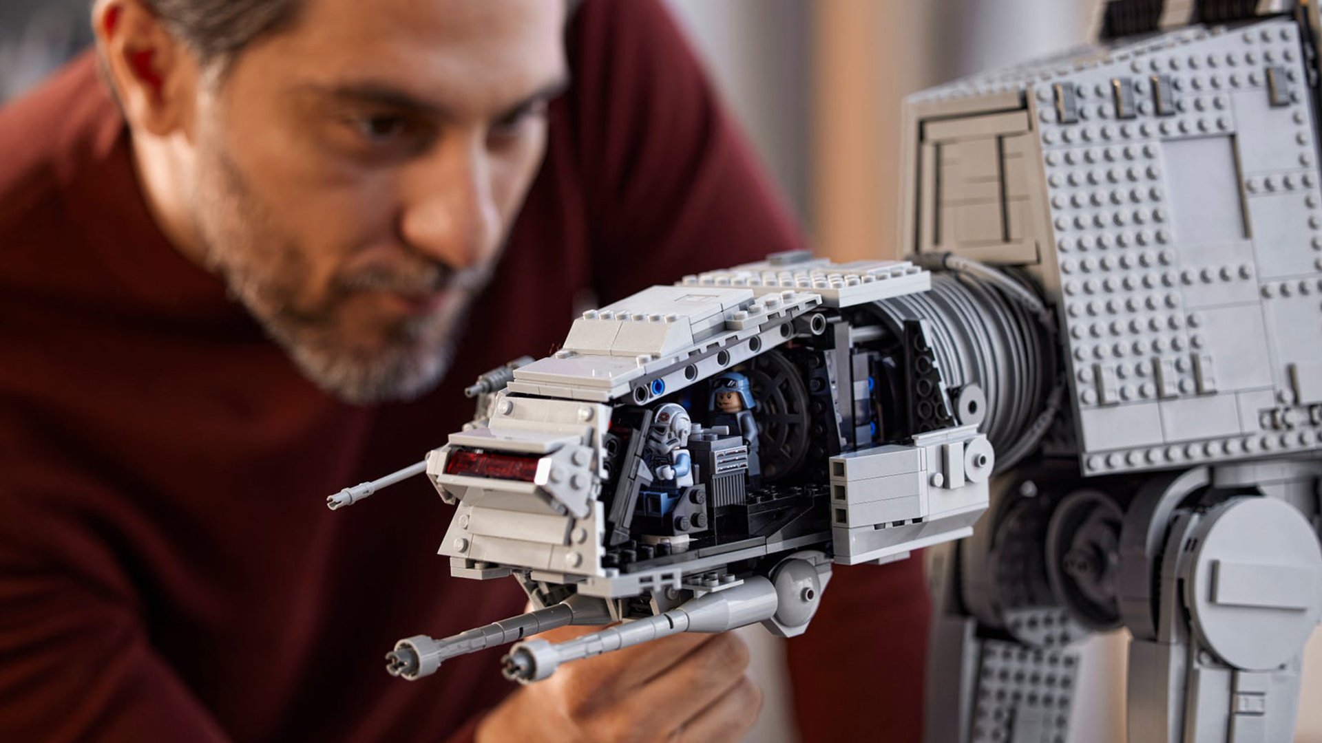Man holding the head of the AT-ST Lego Star Wars