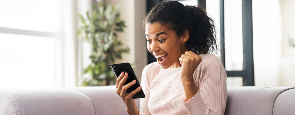 Women excited holding phone
