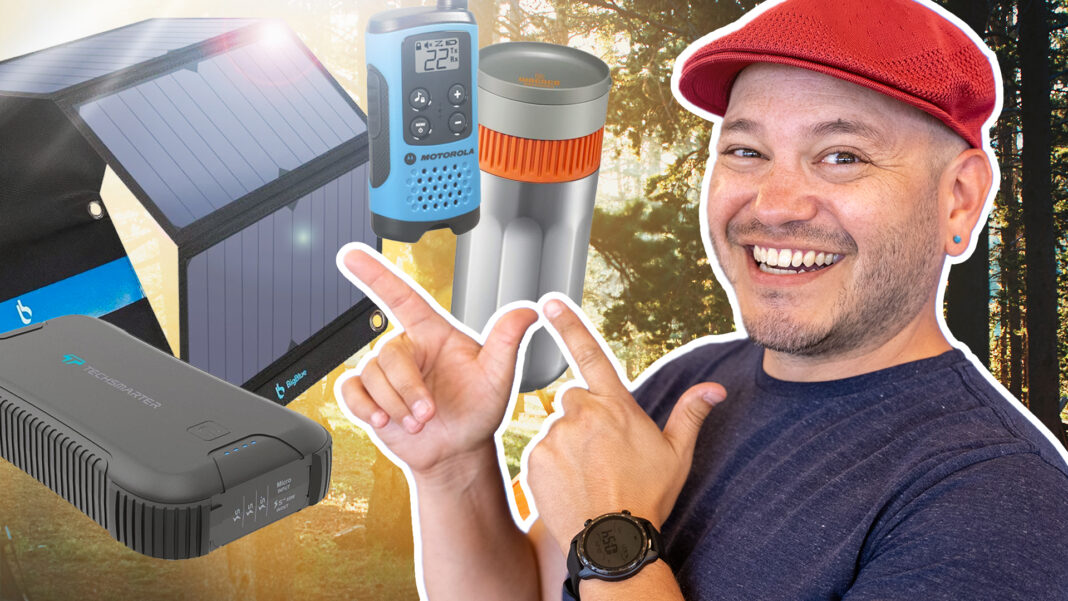 man with red hat smiling, pointing at and standing on forest background with various products (Solor panel, battery pack, walkie talkie) in the foreground