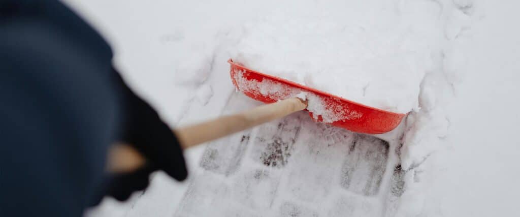 red shovel shoveling snow