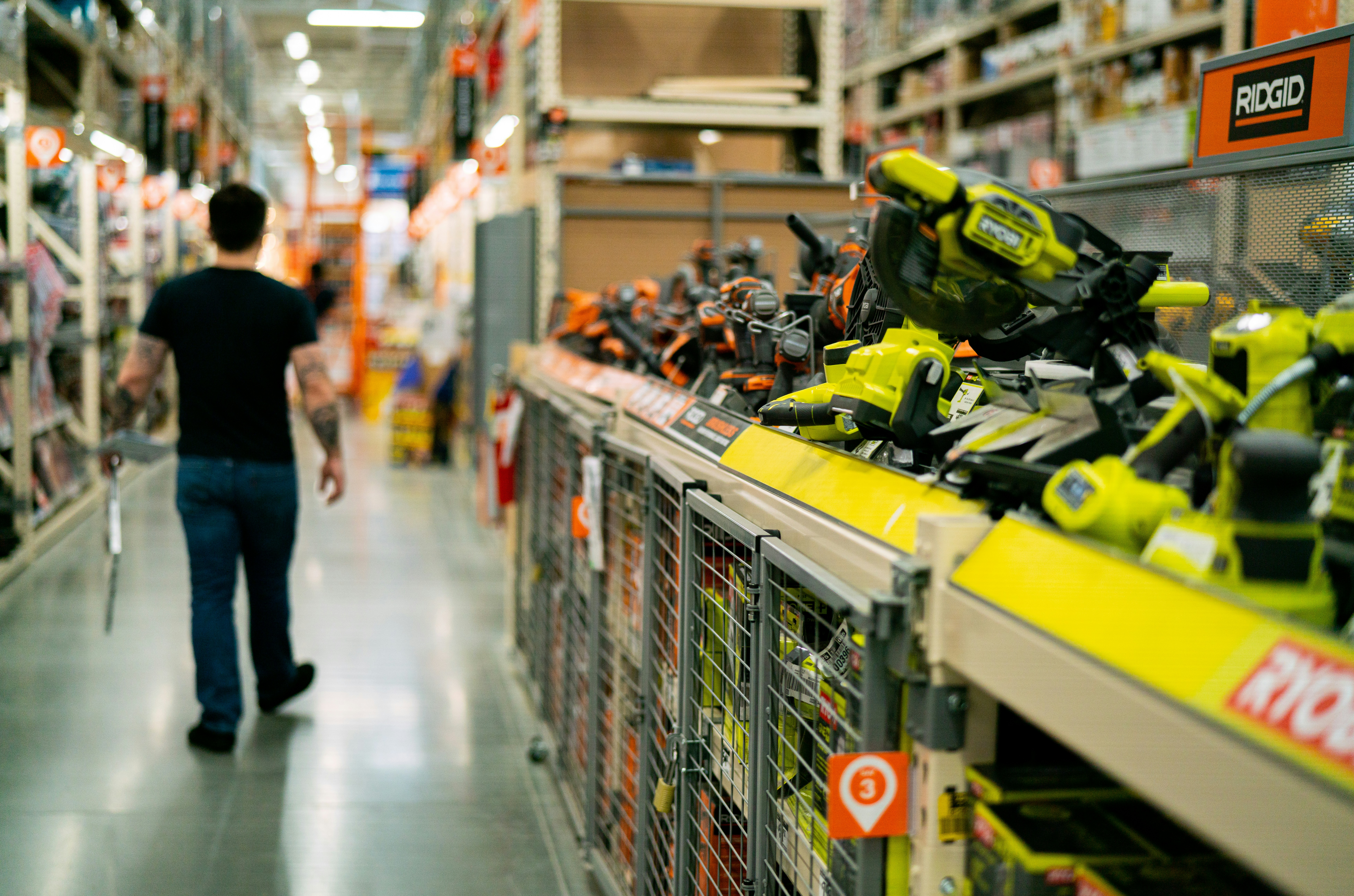 Man walking down the tools isle at a hardware store