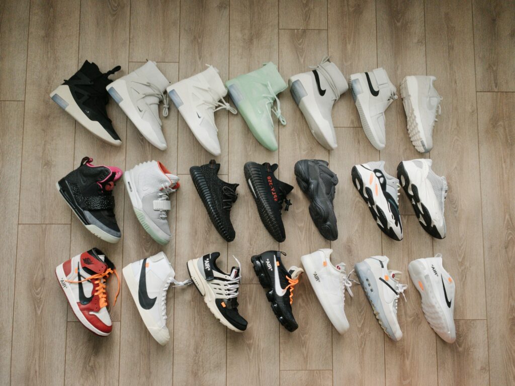 a collection of sneakers laid out on the floor