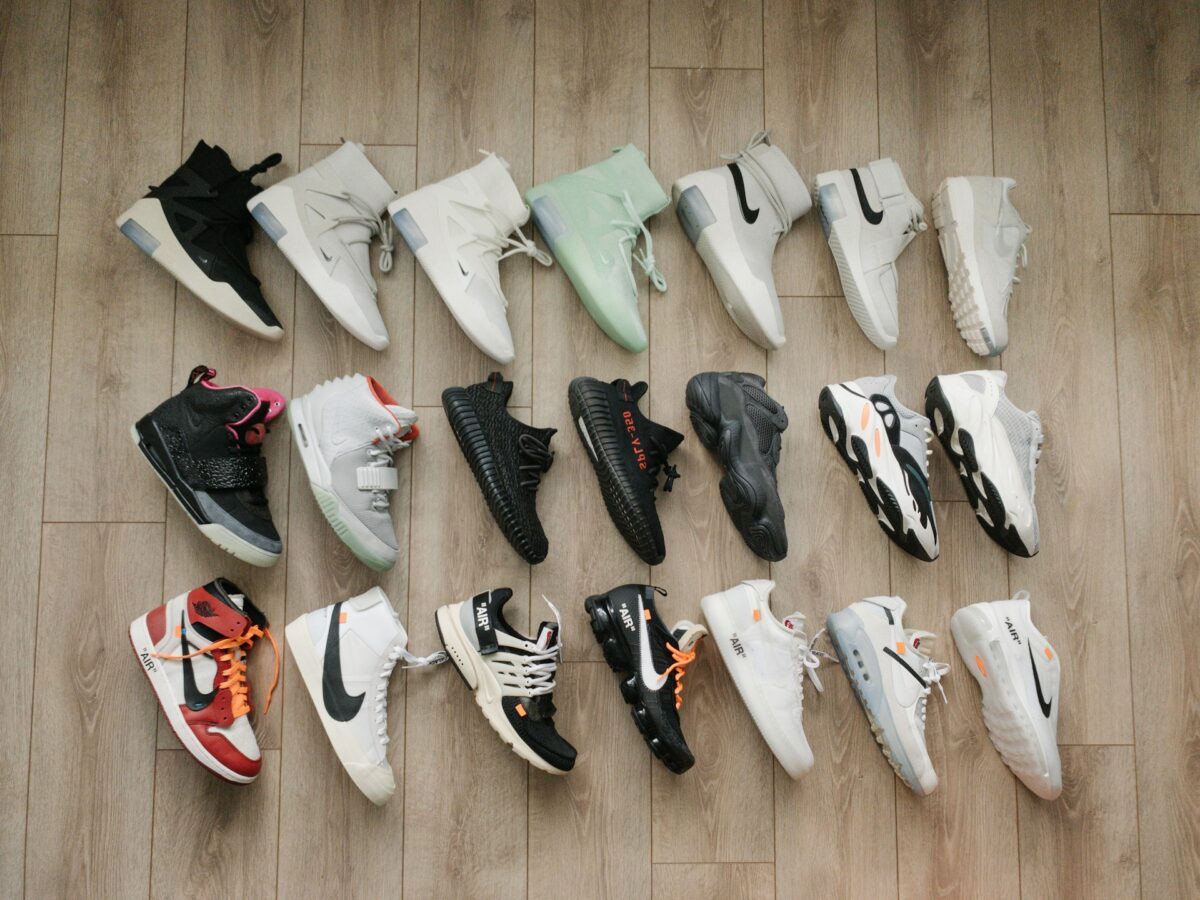 a collection of sneakers laid out on the floor