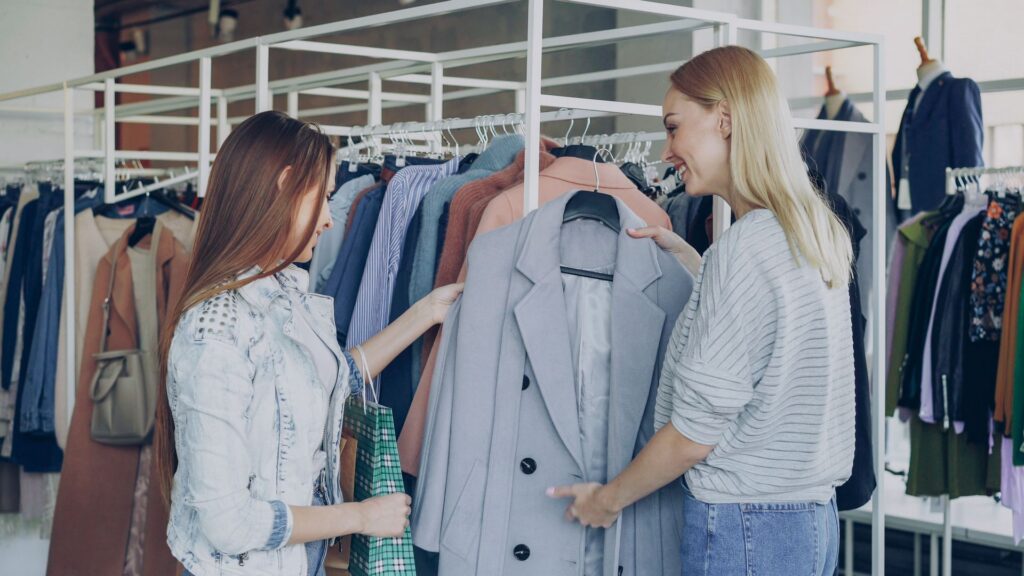 Two women shopping for clothes in a store