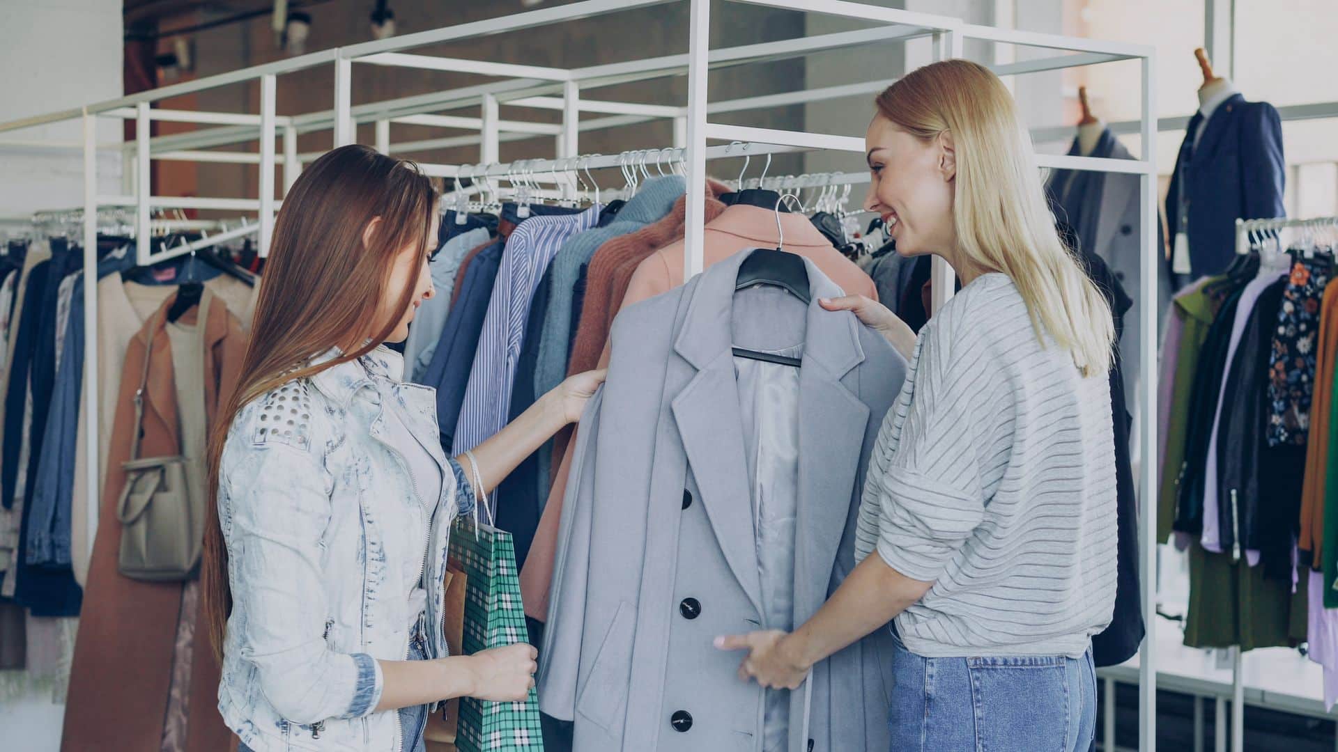 Two women shopping for clothes in a store